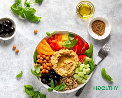 Mediterranean salad in a minimalist bowl with colorful vegetables, cherry tomatoes, cucumber, olives, and herbs